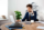 young-successful-businessman-speaking-on-phone-office-background-scaled