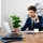 Young successful businessman in suit speaking on phone, sitting at workplace, looking at laptop, office background.